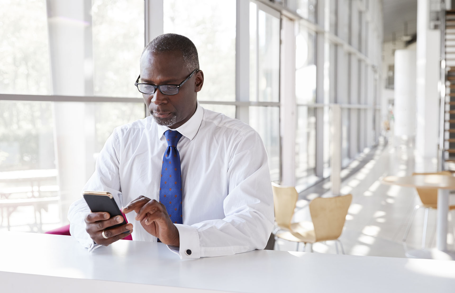 portrait-of-a-smiling-businessman-holding-glasses-2022-03-30-20-23-45-utc.jpg